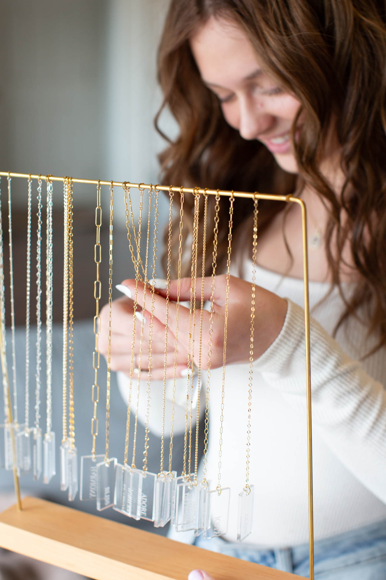 Teen girl looks at gold chain options found in permanent jewelry in upland indiana